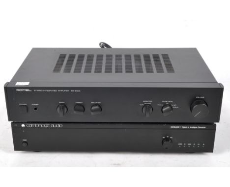 A Cambridge Audio analogue converter DACMAGIC 1, serial number MDAC101583, together with a Rotel Stereo Integrated Amplifier 