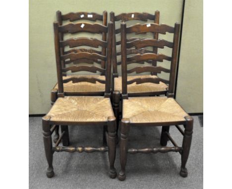 A set of four 19th century elm ladder back chairs with rush seats and turned legs on bun feet, height 99cm