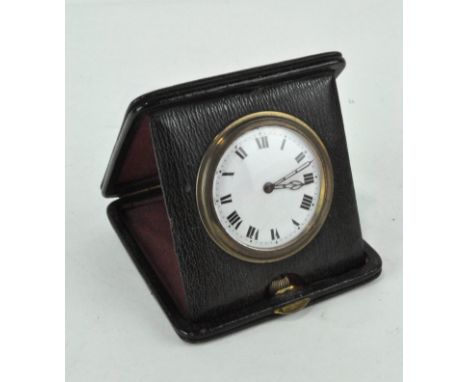 A early 20th century travelling clock, white dial with Roman numerals, diameter 6cm, within a black leather case