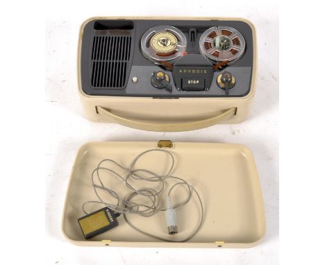 A vintage Grundig Travel reel to reel recorder, together with the plugs and wires, contained within a cream plastic case with