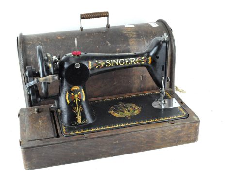 A vintage Singer sewing machine, numbered F7970576, in original carry case
