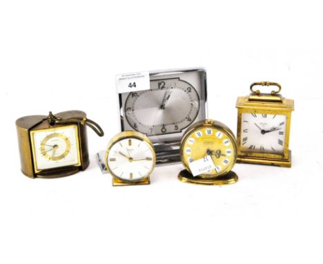 A vintage retro travel alarm clock by Europa, with a brass and ebonised chapter ring, encased within a retractable sprung pro