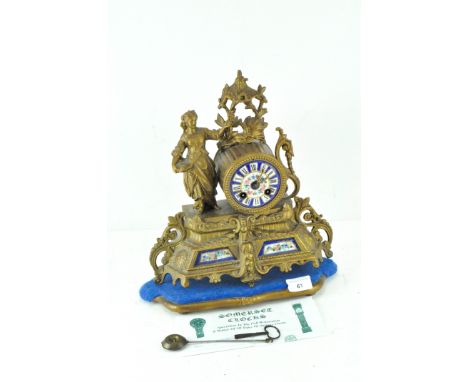 A late 19th-early 20th Century French mantle clock, the enamelled dial with Roman numerals, the spelter frame modelled as scr
