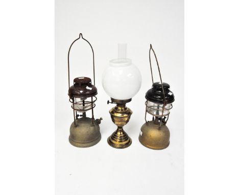 An early 20th century Duplex oil lamp, with original glass shade and funnel, together with two hanging lanterns (glass AF)