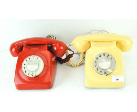 Two vintage telephones, in red and cream cases, with the original fittings and dials