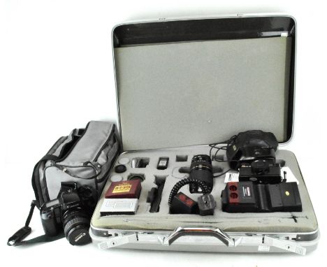 A collection of cameras and lenses, including a Cobra 700AF, Canon Ultrasonic EOS 100 camera and lens, GAF Memo 35 ET and mor