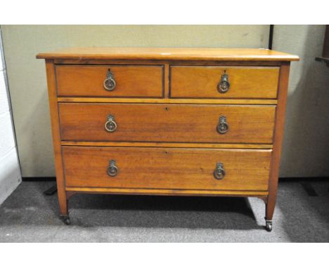 A 20th Century mahogany chest of drawers, two shorter above two longer drawers, raised on wheeled feet, metal ring handles, 8