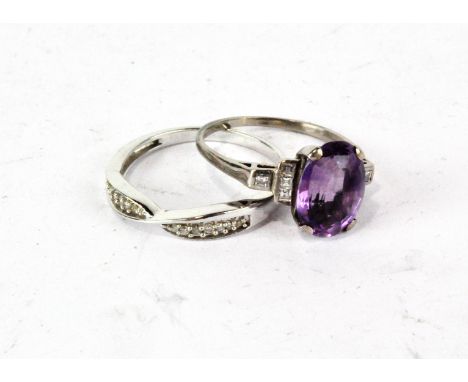 An un-marked white metal dress ring, set central oval amethyst and pave set diamond shoulders, 3.6g and a silver diamond set 