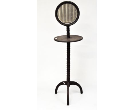 A late 19th century mahogany shaving stand, with adjustable mirror to top above a circular shelf, raised upon tri-pod support