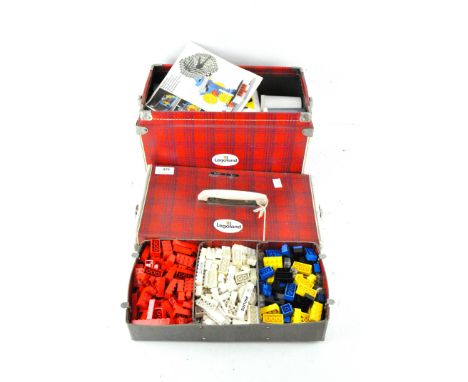 A cased set of vintage Lego, in assorted colours and shapes, contained within a 'Lego System' red tartan carry case with inst