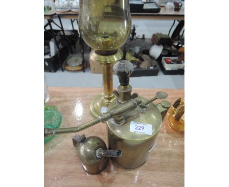 A brass blow lamp, brass sprayer and candle stick 