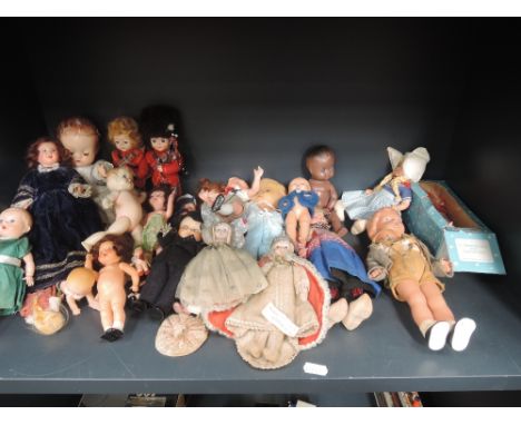 A shelf of celluloid dolls including Rheinische Gummi, Roddy, Harlque etc