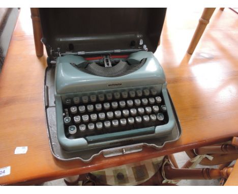 A vintage Imperial typewriter , Good Companion 4 in metal case, in duck egg blue