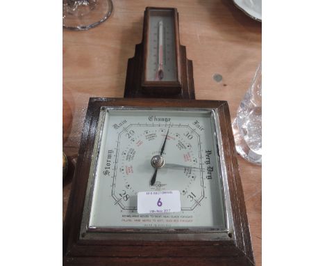 An oak framed barometer and thermometer