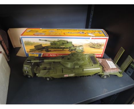 A Dinky die-casts AEC Artic Transporter with Cheiftan tank with netting and six missiles, in original box 616