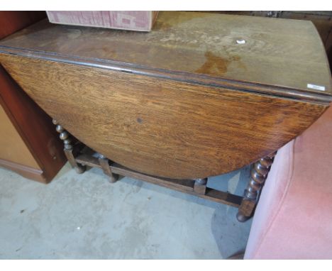 An early 20th Century oak twist gate leg table