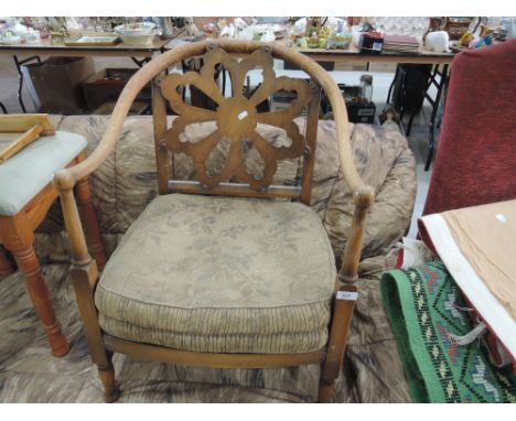 A vintage nursing style arm chair with rosette back