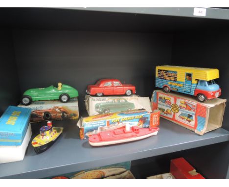 A Mettoy friction driven plastic limousine in original box, a similar racing car in original box, a Wells Brimtoy tinplate an