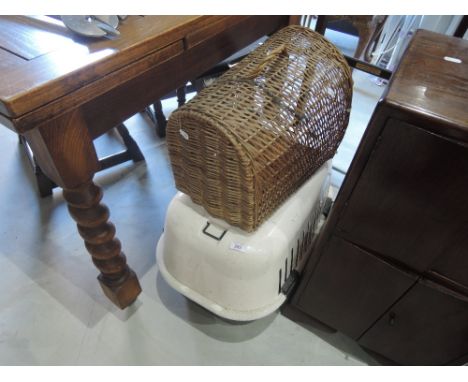 A vintage wicker cat basket and a modern plastic cat box