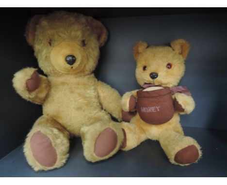 A mid/late 20th century foam filled yellow plush Pedigree teddy bear having plastic nose and eyes, stitched mouth and jointed