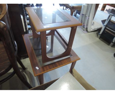 A vintage teak nest of two tables