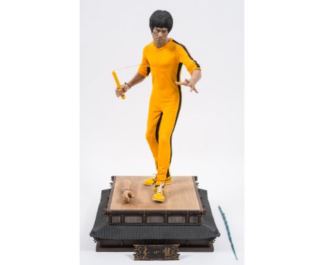 A Blitzway 1/4th scale  40th Anniversary Limited Edition Bruce Lee 'Game of Death' figure:, in yellow suit with nunchaku, on 