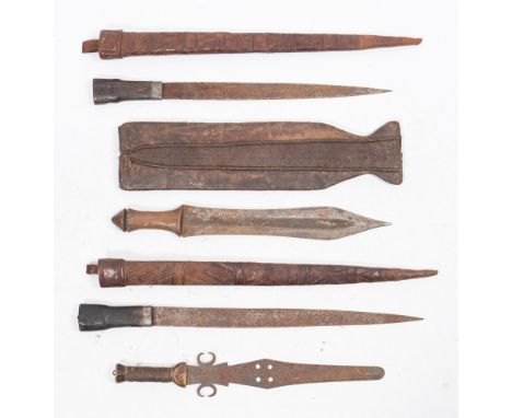 A group of four African short swords:, three in leather scabbards, the largest with geometric decorated panel to front of sca