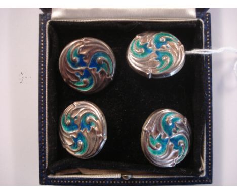 By Liberty and Co- A set of four Cymric silver and green/blue enamel circular buttons:, decorated with swirling foliage, Birm