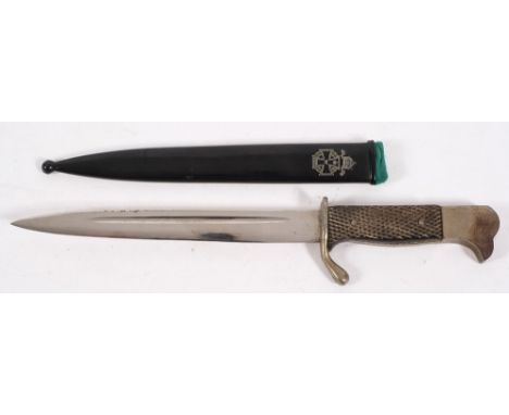 An Imperial German army fighting knife: with 14cm. steel blade and chequered grip, contained in a sheath with Maltese cross a