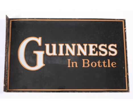 A rectangular double sided enamel shop sign 'Guinness In Bottle':, white and brown text on a black ground, 25.5 x 41cm.