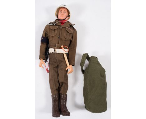 A Palitoy Action Man  painted hair Military Police figure:, in uniform with dog tag, kit bag and accessories.