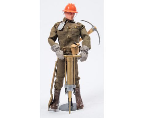 A Palitoy Action Man painted head Combat Construction figure:, with metal dog tag, pneumatic drill and accessories