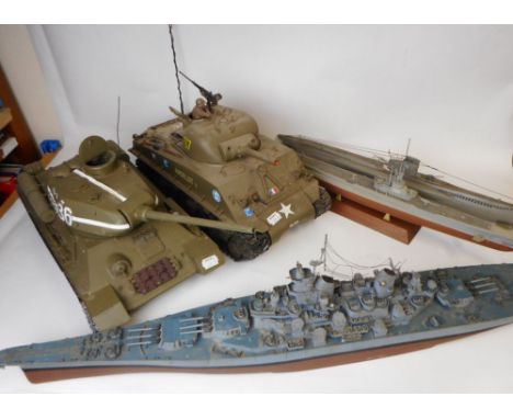 A Large scale model of a Russian T34 tank: a radio controlled Sherman tank, two model submarines and a plastic model of USS M