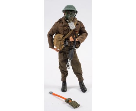 A Palitoy Action Man painted hair British WWII Infantryman:, dressed in uniform with gas mask and Victoria Medal. 