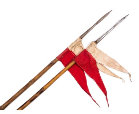 A pair of Cavalry lances:, steel tipped with red/white pennants, white cord grips and brown leather wrist loops, bamboo shaft