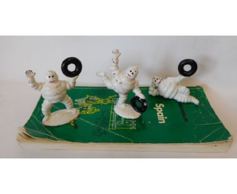 Three cast metal and painted Michelin advertising figures:  and Michelin Spanish guide book.