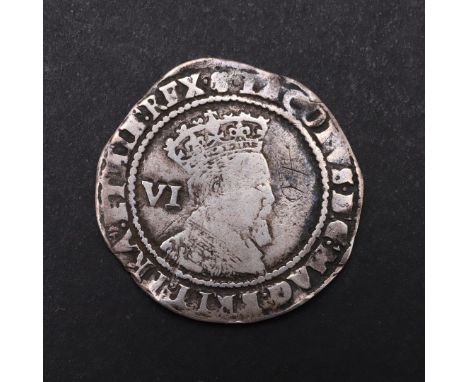 A JAMES I SIXPENCE, 1604-19. A hammered silver sixpence, crowned bust r. with value 'VI' behind, mint mark rose for 1605. Rev