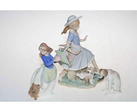 Two Lladro and one Nao figurine depicting dogs.