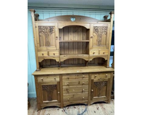 Continental pine dresser, the shelf back with two carved tulip panel doors and four drawers above a base of six drawers and t