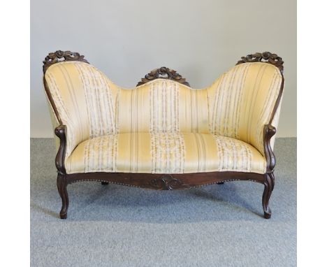 A Victorian carved simulated rosewood and gold upholstered show frame sofa, on cabriole legs, 132cm