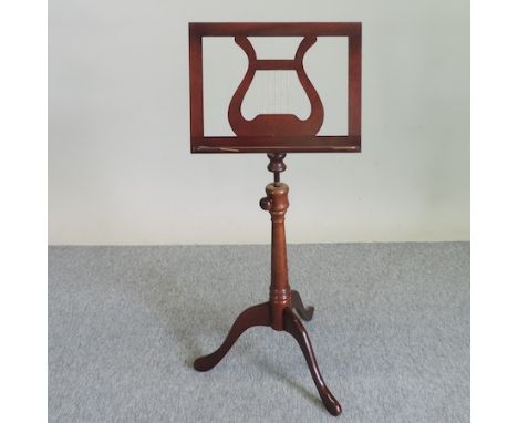 A Victorian style turned music stand, on a tripod base
