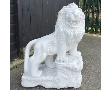 A carved white marble model of a lion, shown standing, 85cm tall