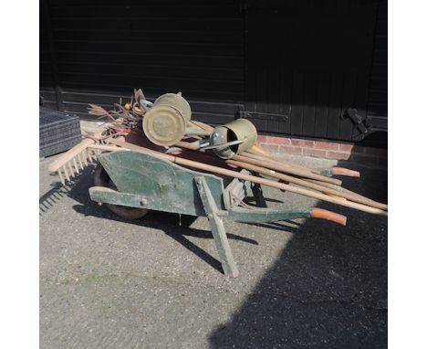 A wooden garden wheelbarrow, 168cm, together with various gardening tools, a black painted metal and wire stand, and a black 