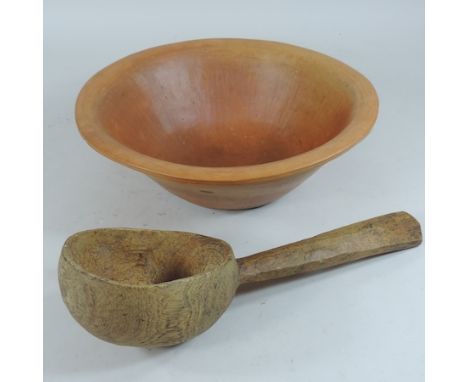 A carved wooden ladle, 33cm, together with a pottery bowl