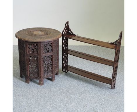 An Edwardian mahogany three tier wall shelf, with fret carved decoration, 57cm, together with an early 20th century Indian ca