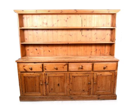 A large pine estate dresser, two shelf panelled back, above four frieze drawers above panelled cupboards, plinth base, width 