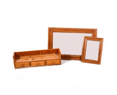 A modern pine framed wall mirror, rectangular plate, 93cm x 61cm; another pine framed mirror, pine shelf with three drawers.