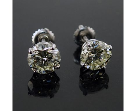 Pair of Approx. 3.59 TW Diamond and 14 Karat White Gold Stud Earrings. Stamped 14K. The diamonds, 1.89ct and 1.70ct, of J-K c