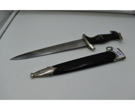 A German SS Officers Dagger c1936, with metal scabbard, black grip with silver eagle and swastika emblem and badge, blade mar