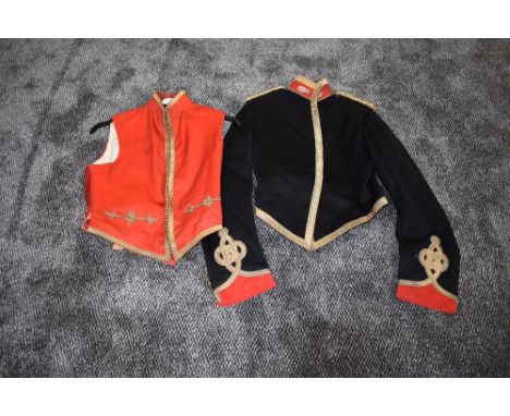 A Victorian British Royal Artillery Mess Dress jacket in black, red and gold having gold epaulettes and trim along with a red